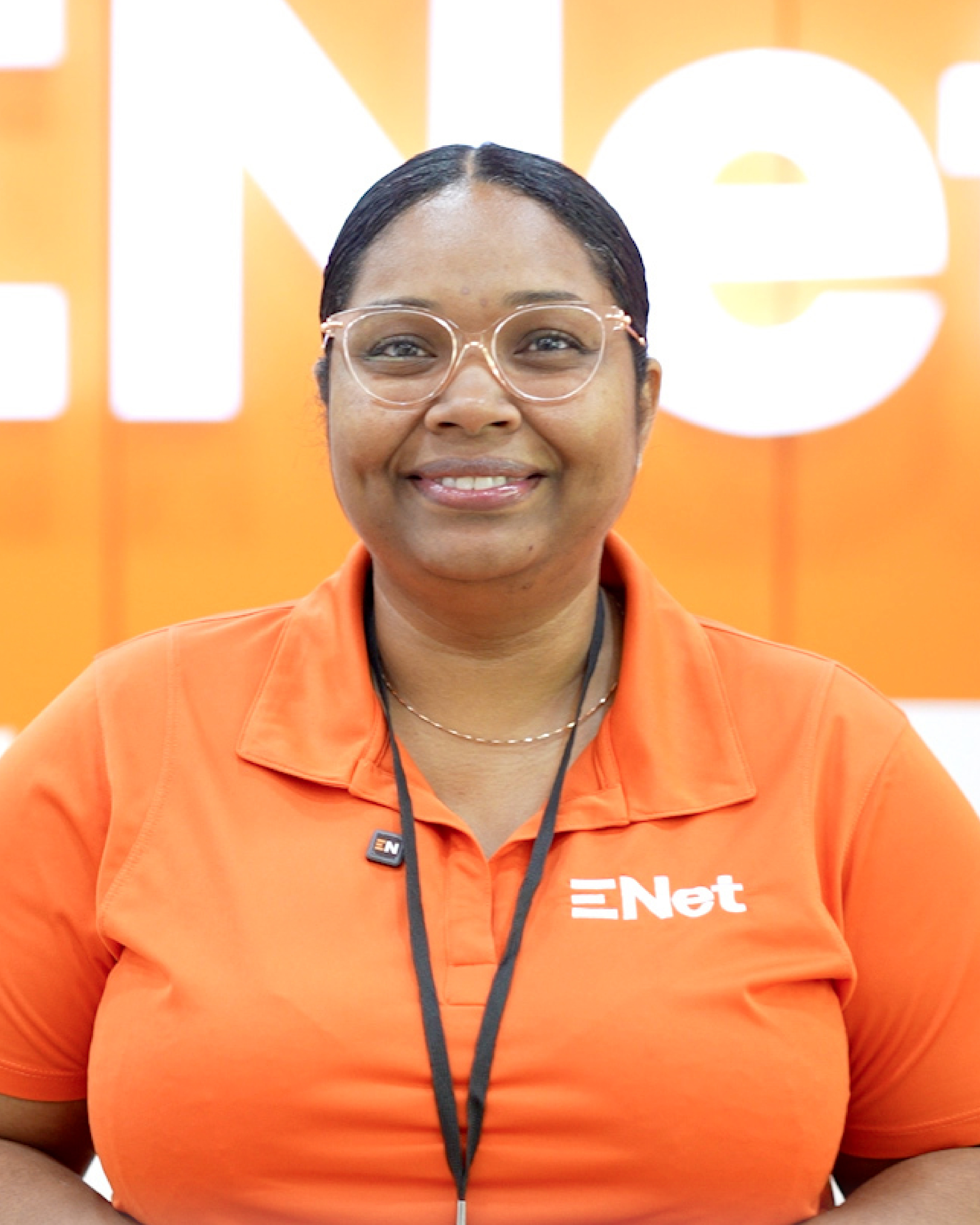 Smiling employee in orange ENet shirt