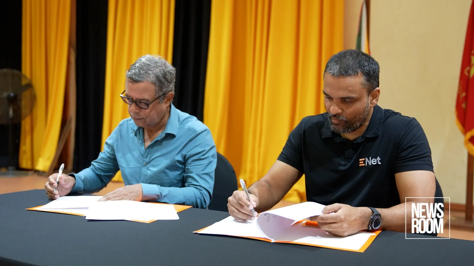 Marcel Gaskin, Chairman of the Queen’s College Board, and Vishok Persaud, Chief Executive Officer of ENet ink the MoU